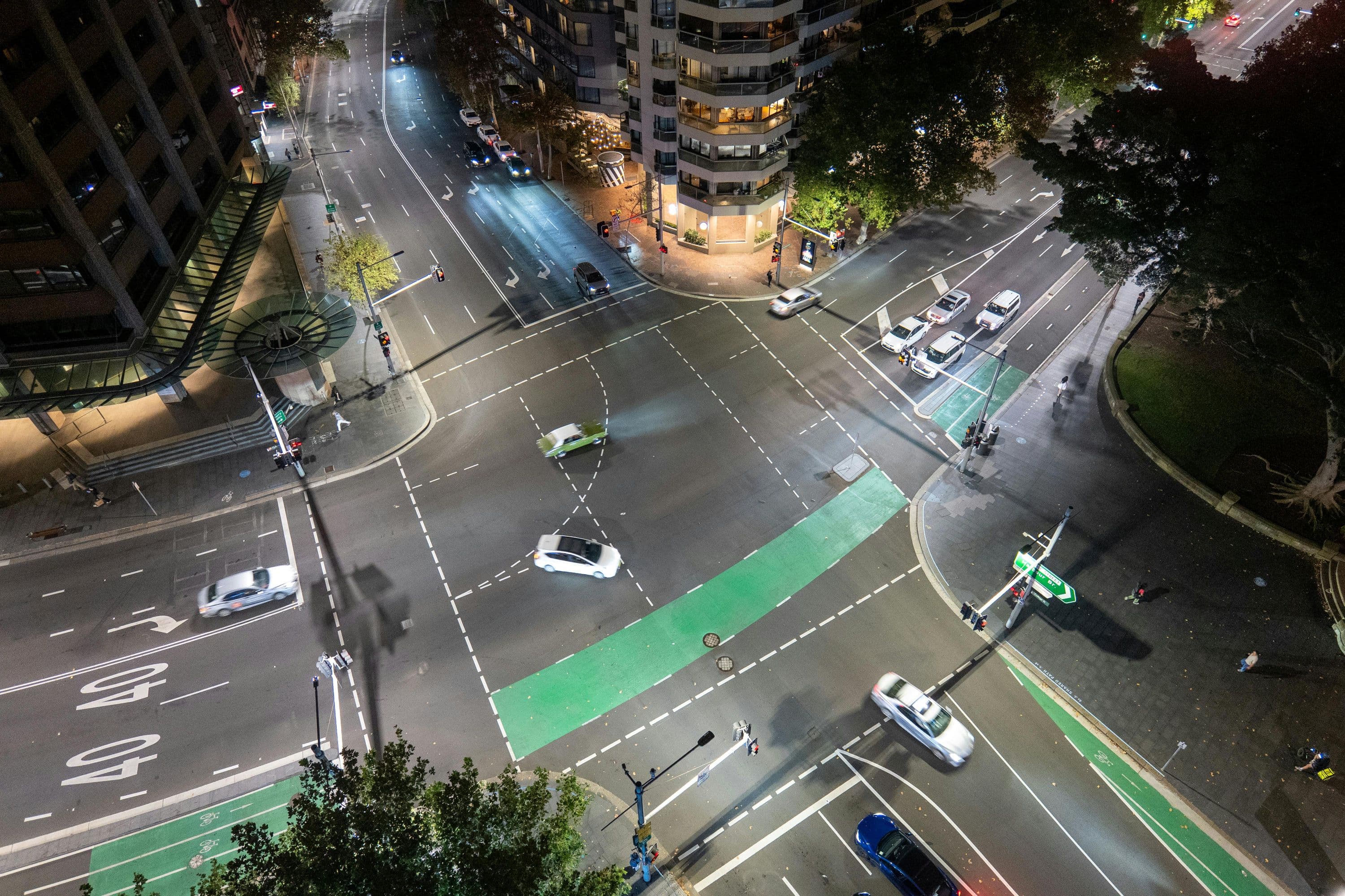 A view from the front of an Australian arterial-road property looking out onto the street, with traffic moving past close to the building